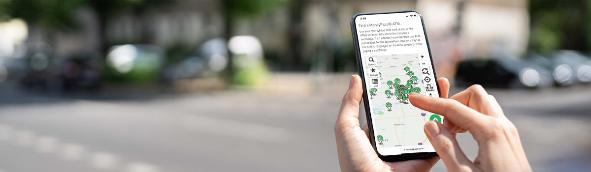 Close up of person locating FREE ATMs on their smartphone at MoneyPass.com
