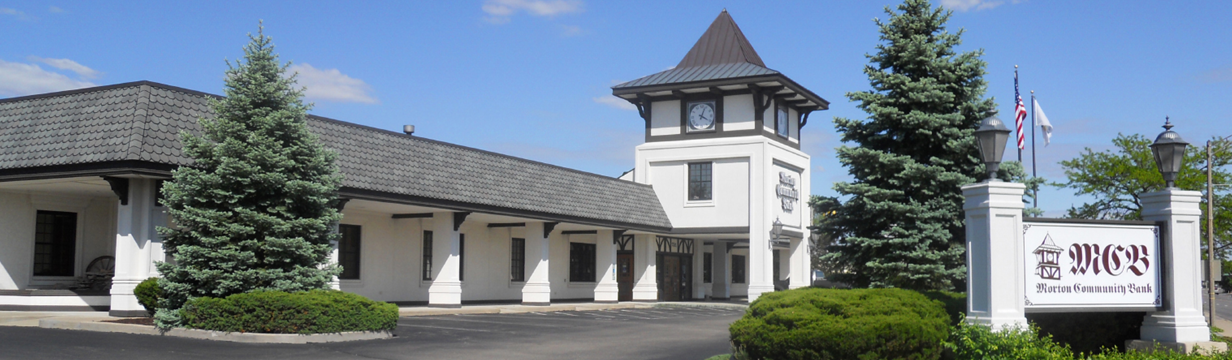 A large white building with a clock tower - Morton Community Bank - Morton Illinois