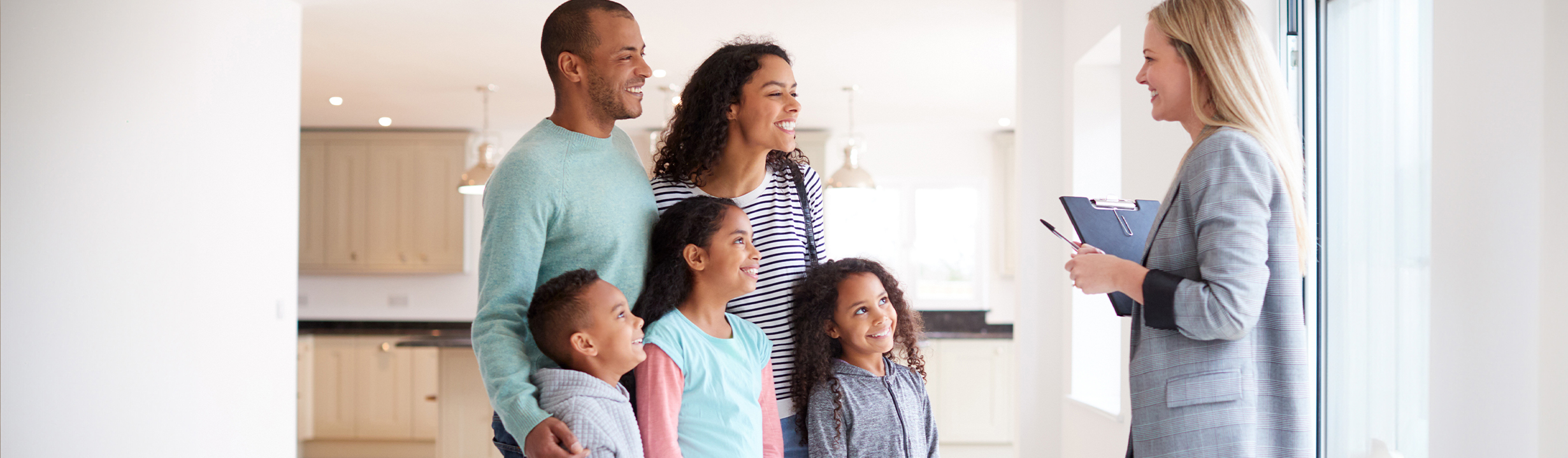 Happy family talking with Realtor in their new home