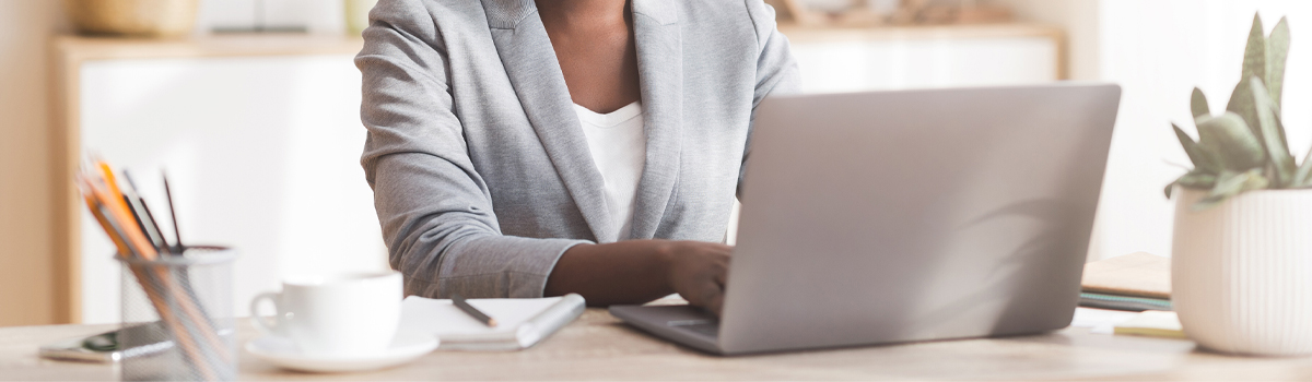 Woman sitting at desk working on laptop